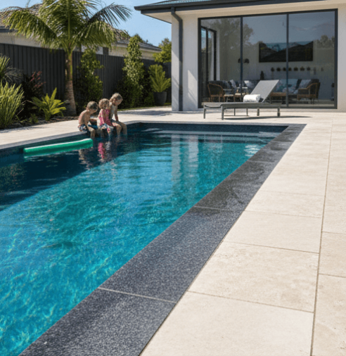 Sample: Family friendly swimming pool area featuring non-slip stone coping and glass fencing