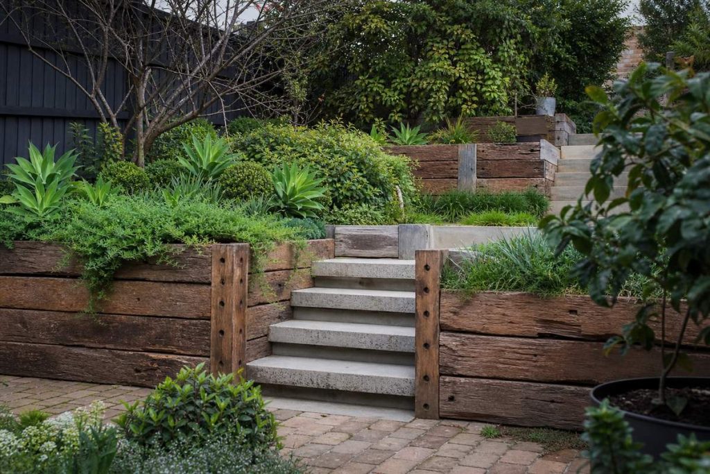 Timber and concrete sleepers used for raised garden beds and retaining wall in Melbourne garden