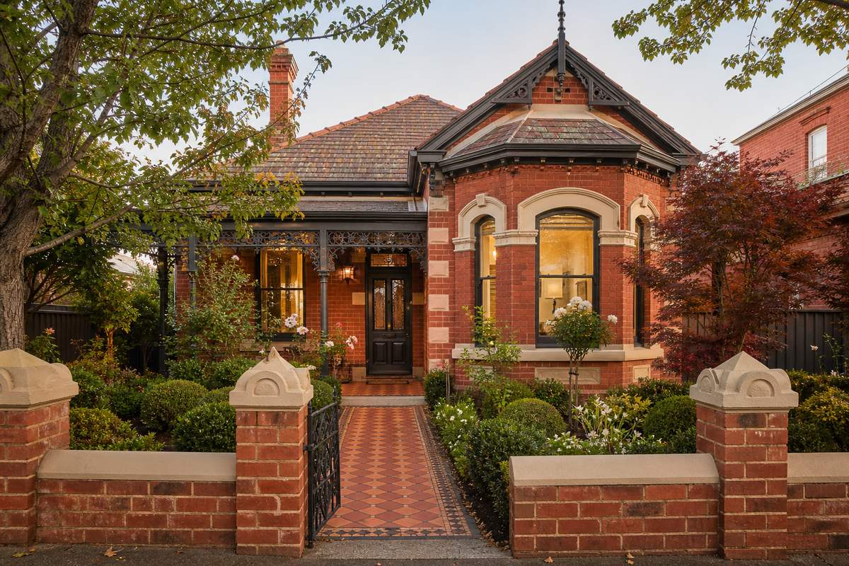 Heritage red brick home in Melbourne with restored brick fence pier caps and clay paver pathway
